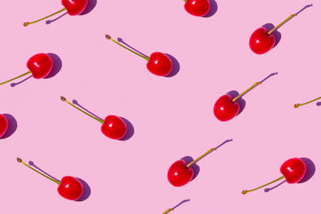 Ripe red sweet cherries on pastel pink background. High quality photoの写真素材