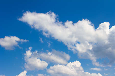 Blue sky with white and gray clouds. Bright sunny cloudscape. High quality photoの写真素材