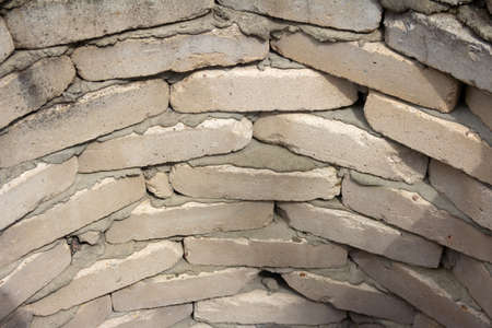 Brickwork in a semicircle of white, gray bricks. The wall of an old well. Grunge vintage texture. High quality photoの写真素材