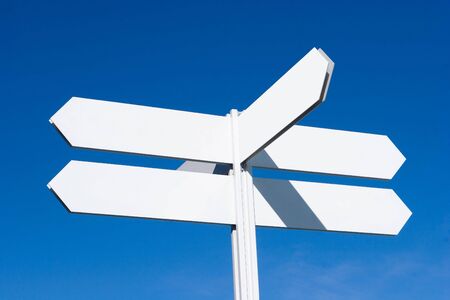 A Blank Directional Sign Post with Blue Skyの写真素材