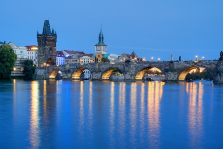 PRAGUE, CZECH REPUBLIC - AUGUST 4: Tourists crossing the Charles Bridge in early evening on August 4, 2012 in Prague, Czech Republic.  Its construction started in 1357 under the auspices of King Charles IV.のeditorial素材