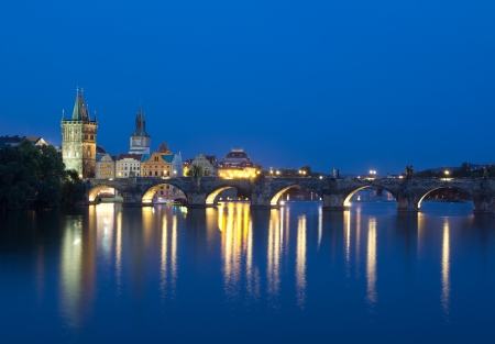 PRAGUE, CZECH REPUBLIC - AUGUST 5: Tourists crossing the Charles Bridge in early evening on August 5, 2012 in Prague, Czech Republic.  Its construction started in 1357 under the auspices of King Charles IV.のeditorial素材