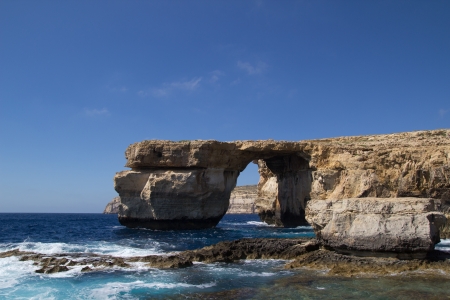 GOZO, MALTA - JUNE 6: The famous stone arch, Azure Window, on a clear day on June 6, 2012 in Gozo, Malta.  The Azure Window has been featured in films and in television series. Although illegal, the Azure Window is a popular cliff diving spotのeditorial素材
