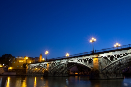 SEVILLE, SPAIN - MAY 14: The Isabel II bridge of Seville, also known as the Triana Bridge, at night on May 15, 2013 in Seville, Spain. Built in 1847-1852, it is the oldest bridge in Seville.  のeditorial素材