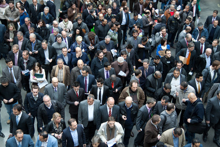VALENCIA, SPAIN - FEBRUARY 11, 2014: A crowd of business people waiting to enter the 2014 Feria Habitat Valencia Trade Fair on the opening day. のeditorial素材