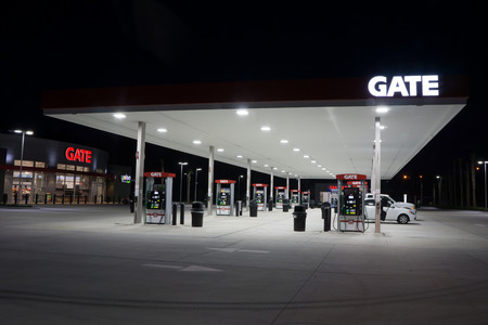 JACKSONVILLE, FL - MAY 5, 2014: A Gate Petroleum gas station at night in Jacksonville. Gate Petroleum is headquartered in Jacksonville and has over 225 gas stations in six states with over 2,200 employees.のeditorial素材