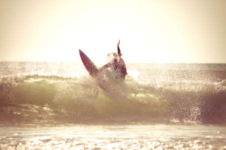Surfing in the early morning with retro effect applied.