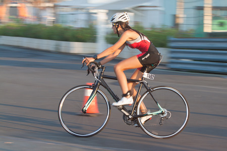 Valencia, Spain - September 6, 2014: Athlete competing in the cycling section of the Women's Toro Loco Valencia Triathlon.のeditorial素材
