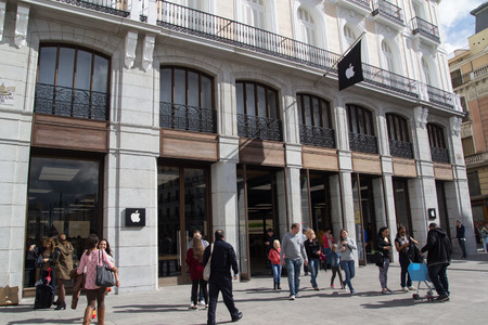 MADRID, SPAIN - OCTOBER 9, 2014: People entering and exiting the new Apple Store in Madrid. Located in the Puerta de Sol Plaza, the store opened on June 21, 2014.のeditorial素材