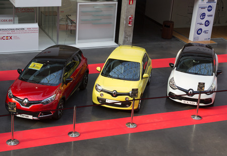 VALENCIA, SPAIN - DECEMBER 4, 2014:  A red Renault Captur, a yellow  Renault Twingo and a white Renault Clio at the Valencia Automovil 2014 Car Show. Renault is a French multinational vehicle manufacturer established in 1899.のeditorial素材