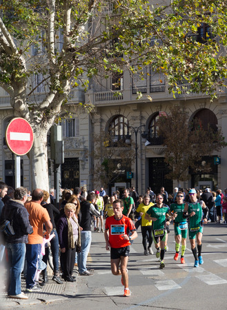 VALENCIA, SPAIN - NOVEMBER 16, 2014: Runners compete in the 2014 Valencia Marathon in Valencia, Spain.のeditorial素材