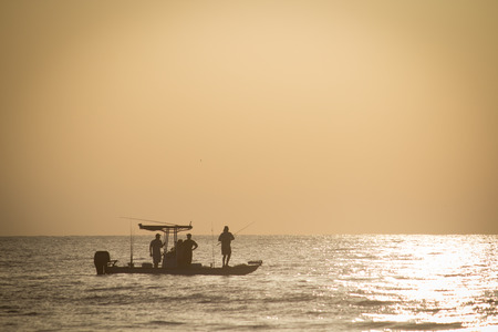 Fishing in early morning off the coast of Jacksonville, Florida.の写真素材