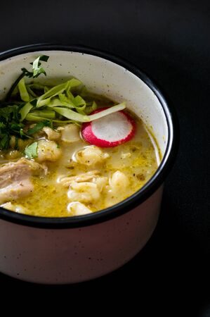 Pozole verde, or green posole is traditionally made with hominy and meat and topped with condiments. Mexican cuisine.の写真素材