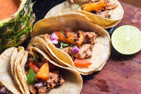 Tacos Al Pastor Shepherd's tacos, known as adobada tacos in the north of Mexico, spiced pork tacos with pineapple and spicy salsaの写真素材