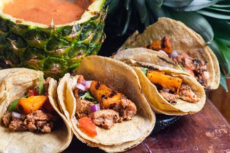 Tacos Al Pastor Shepherd's tacos, known as adobada tacos in the north of Mexico, spiced pork tacos with pineapple and spicy salsaの写真素材