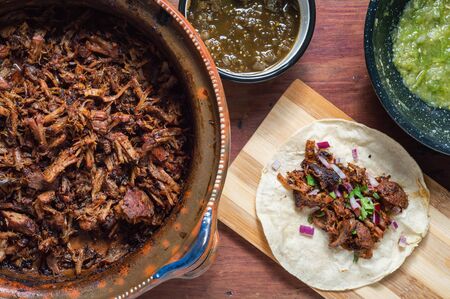 Carnitas tacos with red onion and raw green salsaの写真素材