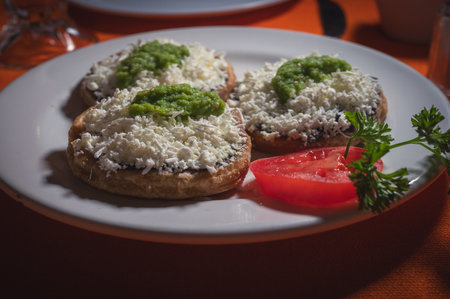 Acapulco Style Mexican Picaditas. Corn Sopes With Black Beans, Cheese and Green Salsa.