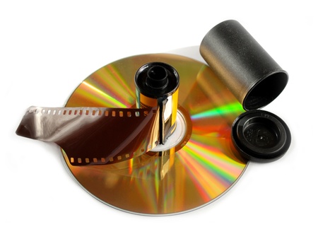 Film roll and compact disk on white background