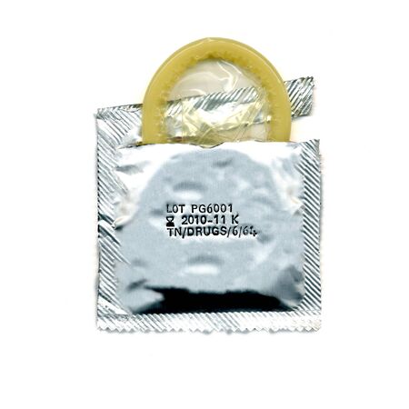 Torn condom pack over white backgroundの写真素材