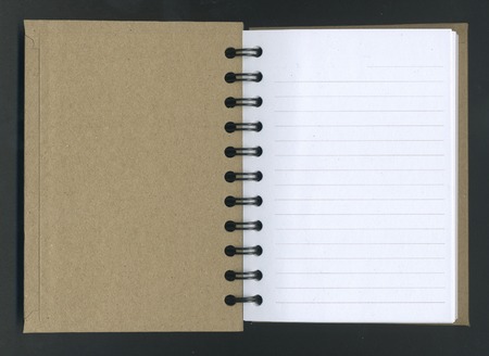 Image of open spiral notebook over black backgroundの写真素材