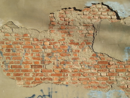 Background image of a cracked red bricks wallの写真素材