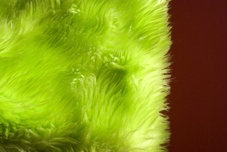 Close-up background of a green synthetic fur