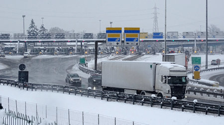 Freight traffic on the highway in winter. Heavy snowfall.の写真素材