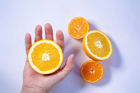 Some citrus fruits cut on a white backgroundの写真素材