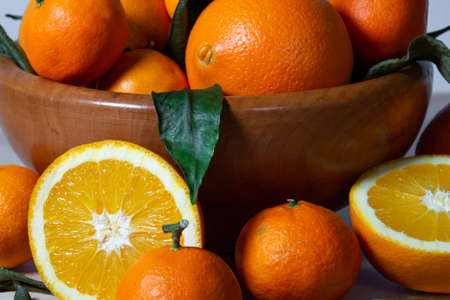 Some oranges in a basket over a wooden surfaceの写真素材