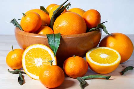 Some oranges in a basket over a wooden surfaceの写真素材