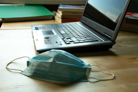 Milan / Italy - May 29,2020 - Smart working with laptop and medical maskのeditorial素材