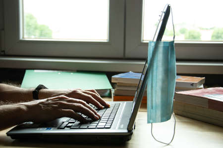Milan / Italy - May 29,2020 - Smart working with laptop and medical maskのeditorial素材