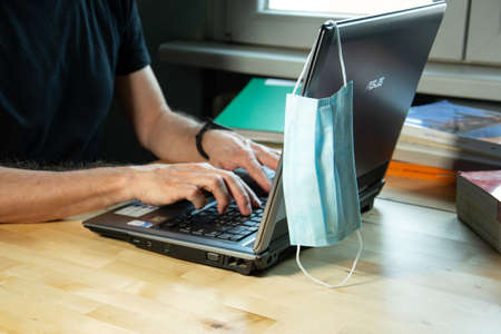 Milan / Italy - May 29,2020 - Smart working with laptop and medical maskのeditorial素材