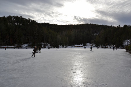 Frozen lake and people skatingの写真素材