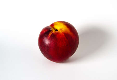 A peach on a white backgroundの写真素材