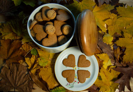 Cookies on a plate decorated with background of autumn leaves.の写真素材