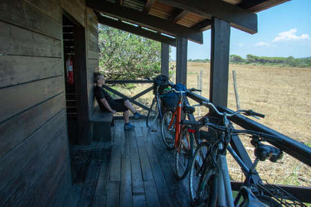 Albarese,Grosseto,Italia - July 29,2021 - Woman with bicycle looking at the countryのeditorial素材