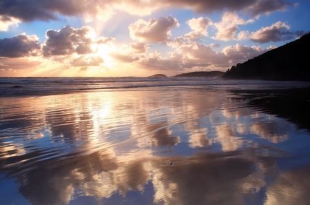 Sunset clouds reflected in the shallows of Whisky Beach, Wilson's Promontory, Australiaの写真素材