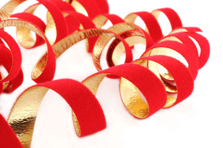 Curly red and gold ribbon on a white backgroundの写真素材
