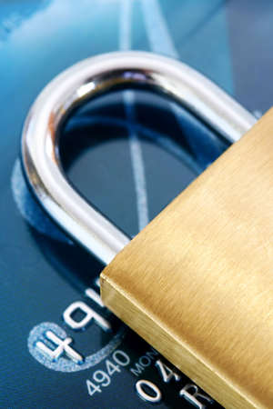 Security:  Brass padlock on credit card.の写真素材
