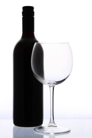 Wine bottle and glass, reflected.の写真素材