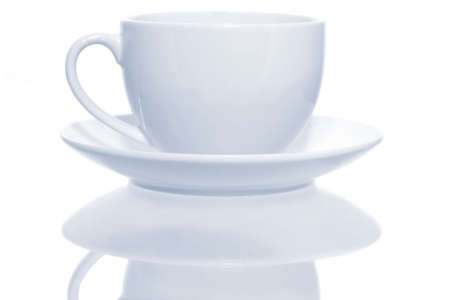 Classic white coffee cup and saucer, reflected.  High-key effect, with blue tone.の写真素材