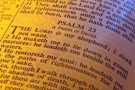 Close-up of Bible page showing Psalm 23.  The Lord is my shepherd.  Warm lighting.の写真素材