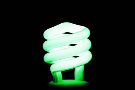 Compact fluorescent light, with green tone.  A conservation message.の写真素材