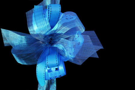 Pretty blue gift ribbons, on black background.  Lovely festive bows.の写真素材