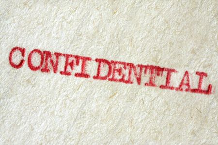 "Confidential" typed on vintage typewriter, on aged paper.の写真素材