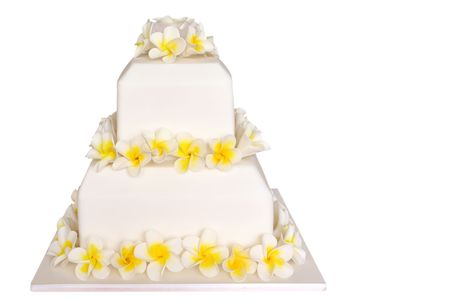Wedding cake decorated with frangipani or plumeria flowers.  Isolated on white.の写真素材