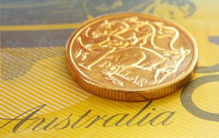 Australian one dollar coin on a fifty dollar note.  Close-up view, with shallow depth of field.の写真素材
