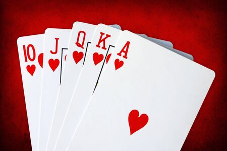 Royal flush on red grunge background.  Heart suit.