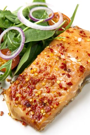 Smoked salmon with chili flakes and a salad of arugula, cherry tomatoes and onion.の写真素材